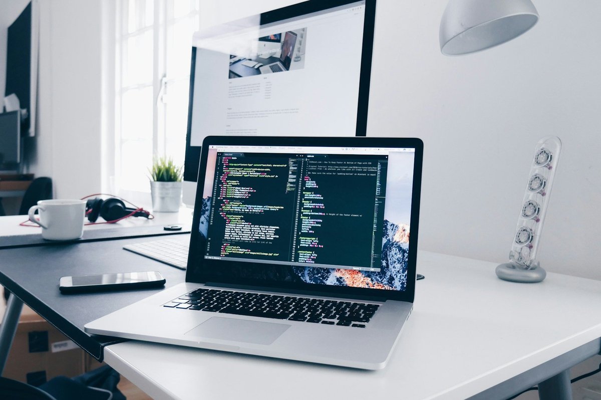 Laptop and code on a bright design studio desk.